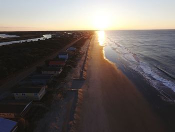 Scenic view of beach against sky during sunset