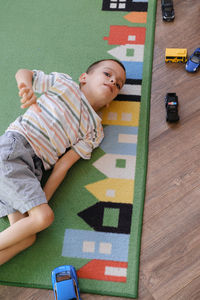 Child with cerebral palsy disability playing on mat, having fun. kid having physical and mental