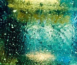 Full frame shot of water drops on car window
