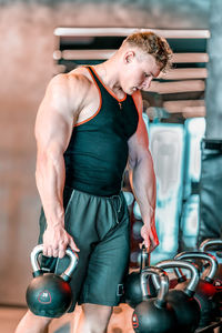 Portrait of young woman exercising in gym