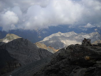 Scenic view of mountains against cloudy sky