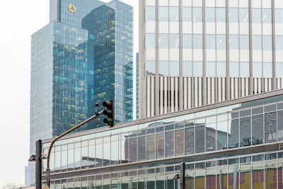 Low angle view of modern glass building in city