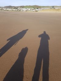 Shadow of people on beach