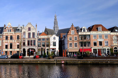 Haarlem, netherlands. traditional dutch houses and cafes lining the river sparne in springtime.