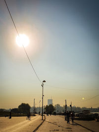 Street lights against sky during sunset