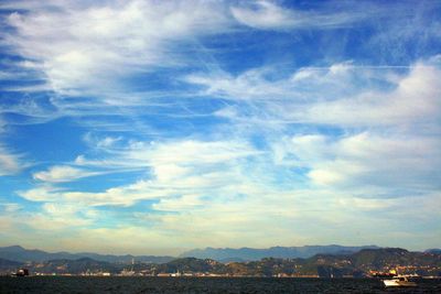 Scenic view of cityscape against blue sky