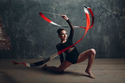 Gymnast girl dancing with ribbon