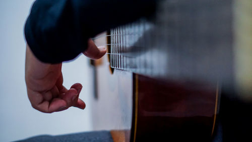 Close-up of hand playing guitar