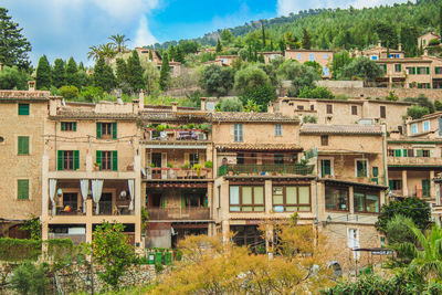 Buildings in town against sky