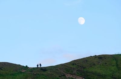 Scenic view of mountains against blue sky