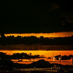 Silhouette of tree against dramatic sky