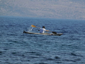 People enjoying in sea against sky