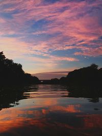 Scenic view of lake against romantic sky at sunset