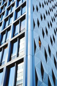 Low angle view of modern glass building in city