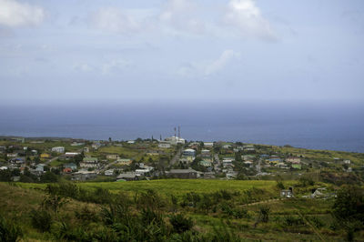 Scenic view of sea and buildings against sky