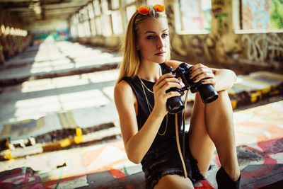 Young woman holding binoculars