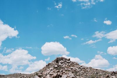 Low angle view of mountain against blue sky