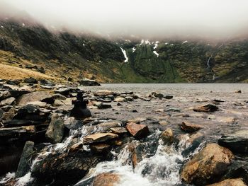 Scenic view of waterfall against sky