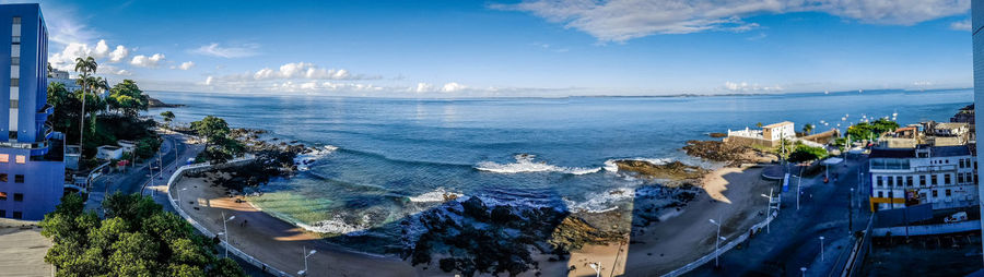 Panoramic view of palm trees against sky