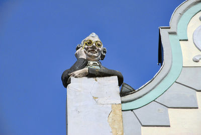 Low angle view of statue against blue sky