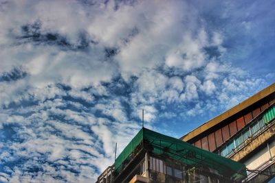 Low angle view of building against cloudy sky