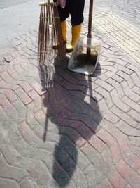 Low section of people standing on tiled floor