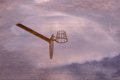 Low angle view of airplane flying against cloudy sky