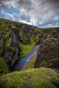 Scenic view of waterfall against sky