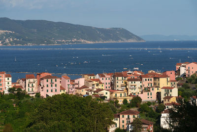 High angle view of townscape by sea against sky