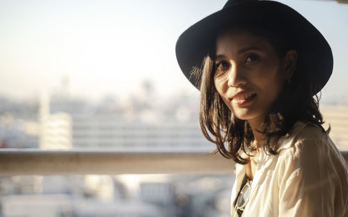 Portrait of smiling woman standing outdoors