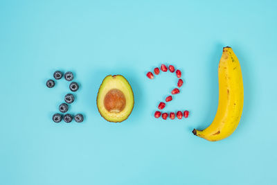 High angle view of fruits against blue background