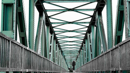 Low angle view of bridge amidst buildings