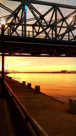 Bridge over river at sunset