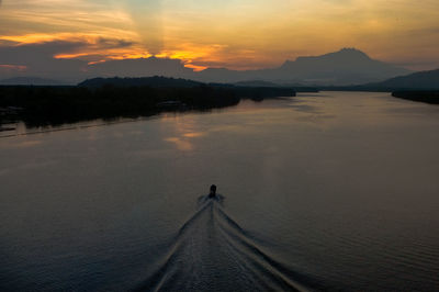 Scenic view of lake against dramatic sky