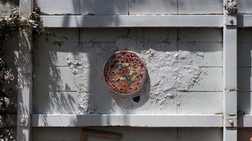 Close-up of circular object on wall