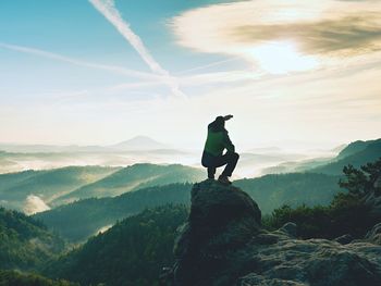 Man standing on mountain against sky