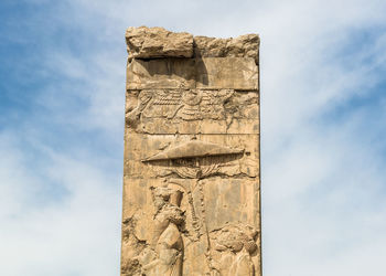 Low angle view of carvings on stone column