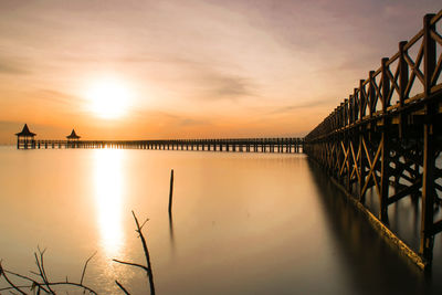 Silhouette bridge against sky during sunset