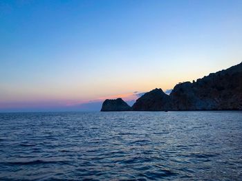 Scenic view of sea against clear sky during sunset