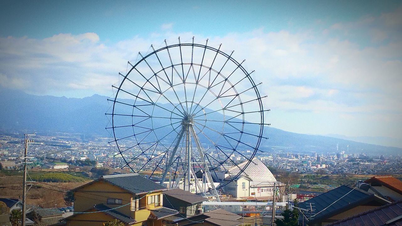 sky, building exterior, built structure, architecture, outdoors, ferris wheel, cloud - sky, arts culture and entertainment, amusement park ride, no people, amusement park, day