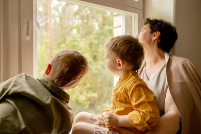 Happy grandmother and her grandsons enjoy time together. positive middle age woman