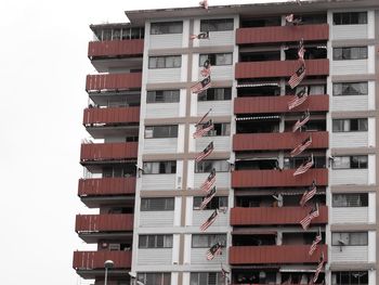 Low angle view of flags hanging against buildings