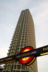 Low angle view of sign board against sky