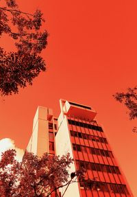 Low angle view of communications tower against sky at sunset