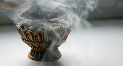 Close-up of glass container on table