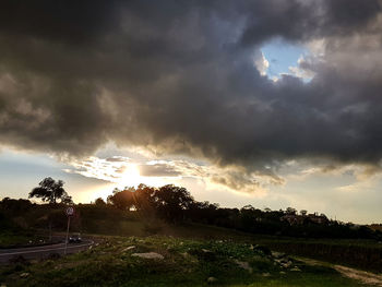 Scenic view of field against sky during sunset