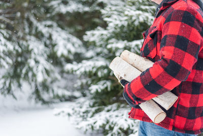 Midsection of person standing on snow covered land