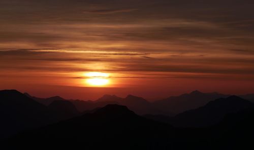 Scenic view of silhouette mountains against sky during sunset