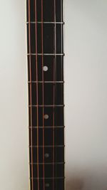 Close-up of guitar against white background