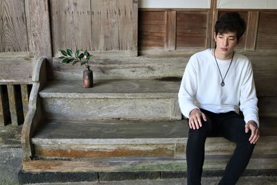 Portrait of young man sitting on steps